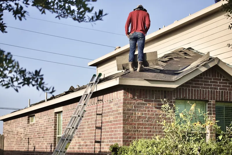 Professional roofer working on a residential roof in Woodlane